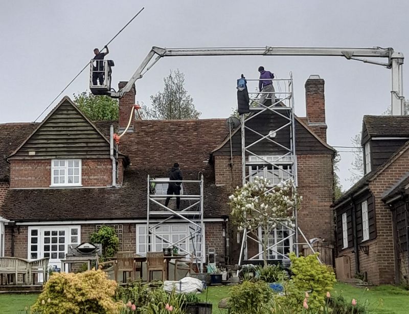 The Roof Moss Cleaners using cherry picker and scaffolding to clean roof safely and professionally in Toddington, Bedfordshire